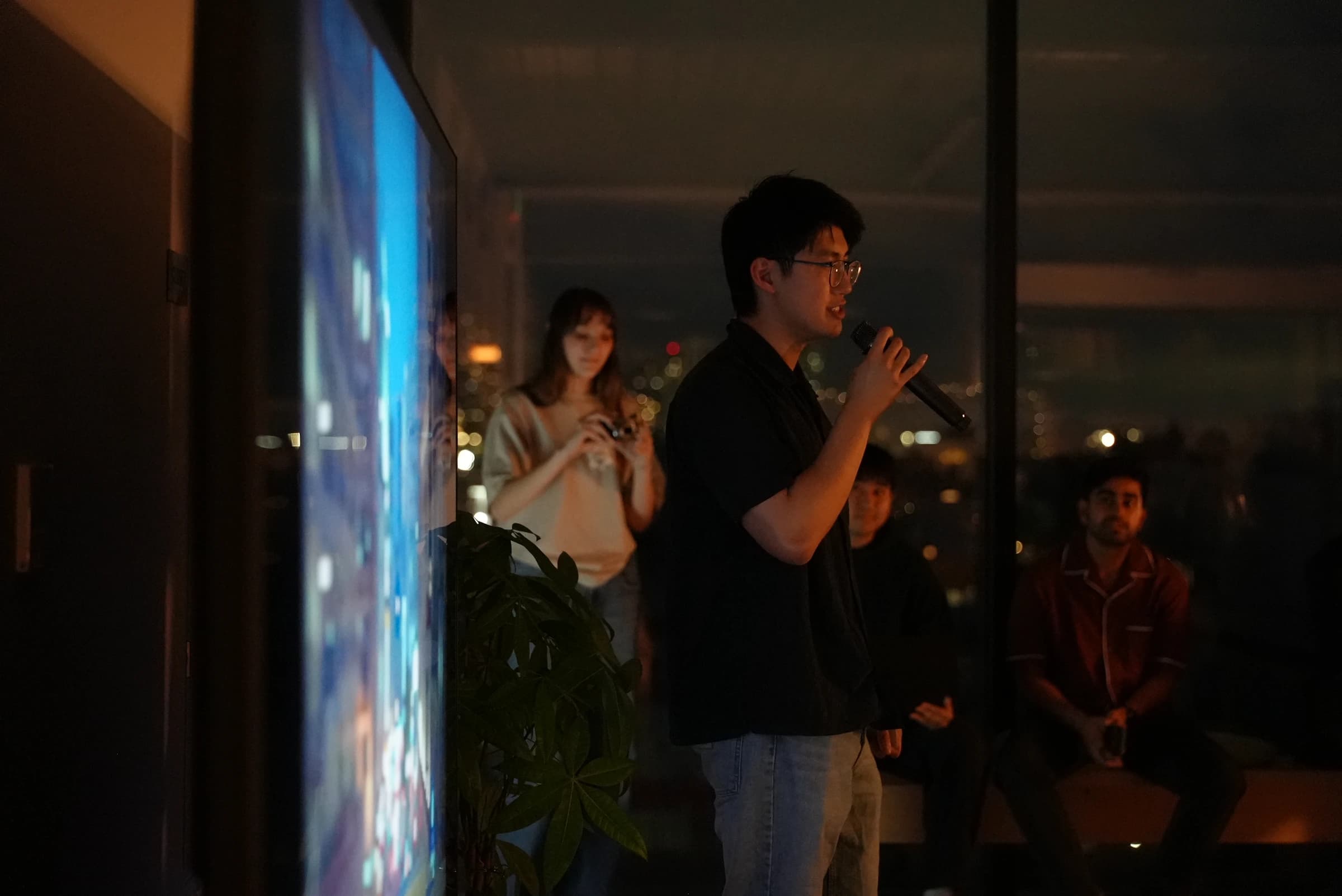Tomo team speaking at an evening event